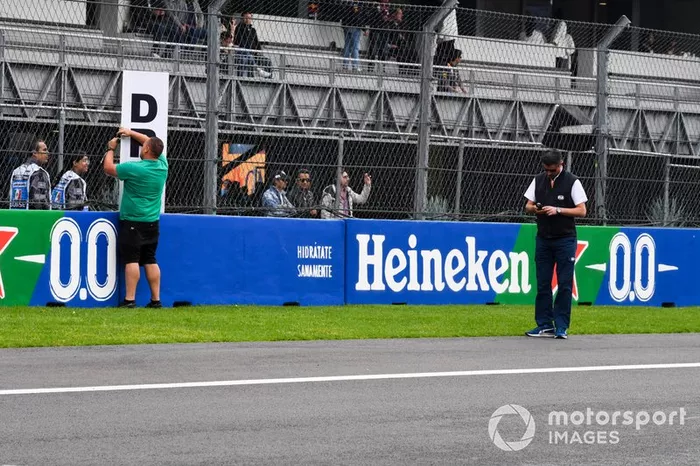 Michael Masi, Race Director, FIA, assists with the installation of DRS zone marker sign