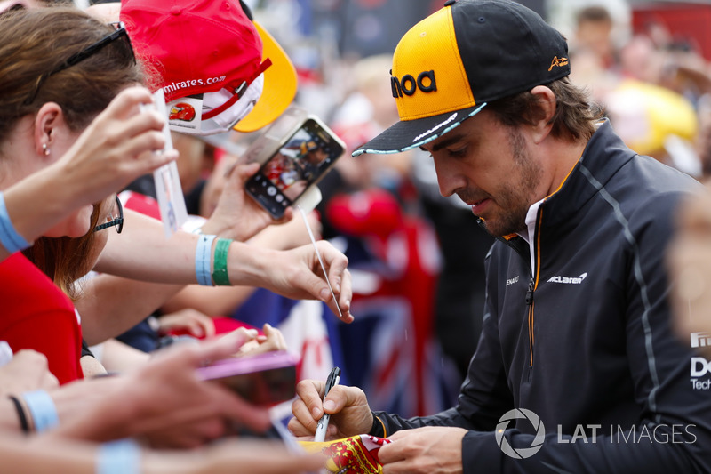 Fernando Alonso, McLaren, signs autographs for fans