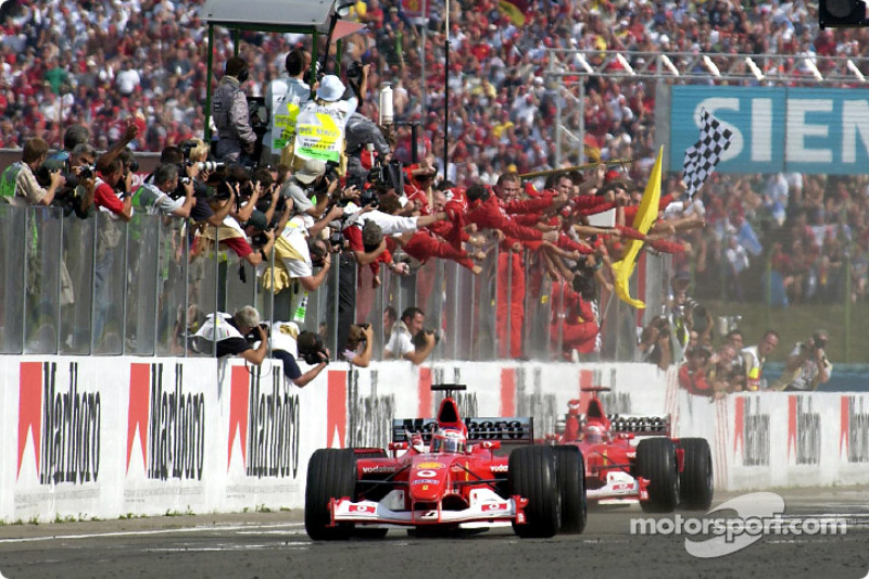 Rubens Barrichello taking the checkered flag in front of Michael Schumacher