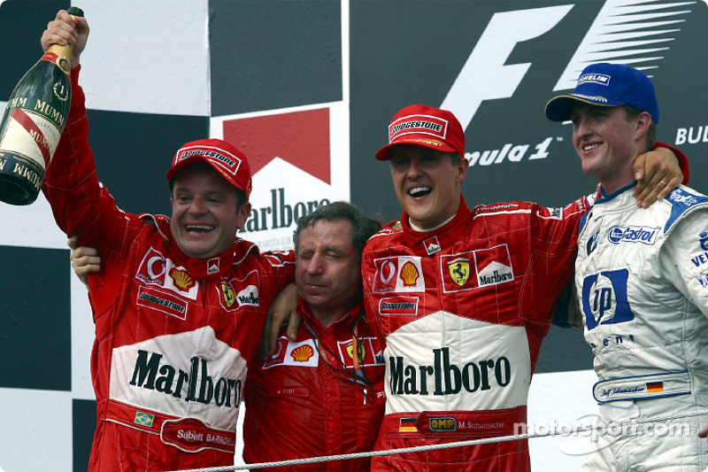 The podium: race winner Rubens Barrichello with Jean Todt, Michael Schumacher and Ralf Schumacher