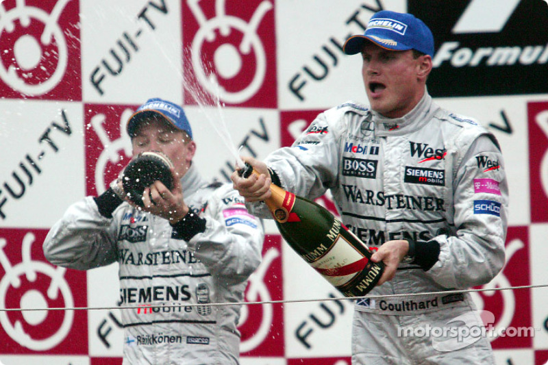 Podium: champagne for Kimi Raikkonen and David Coulthard