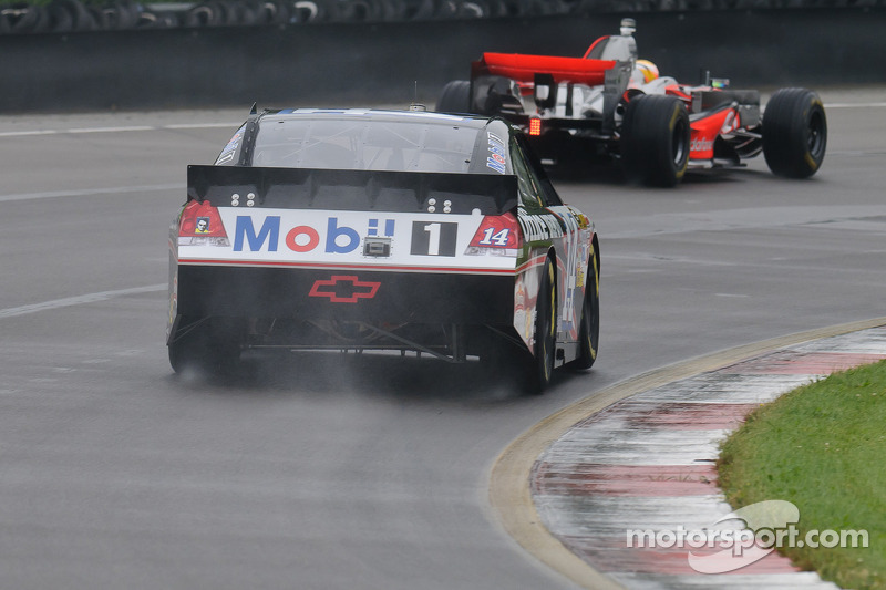 Tony Stewart in his Chevy Impala Sprint Cup car and Lewis Hamilton in his McLaren MP4-23