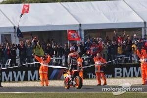 Race winner Casey Stoner celebrates