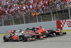 Timo Glock, Marussia F1 Team is passed by Lewis Hamilton, McLaren