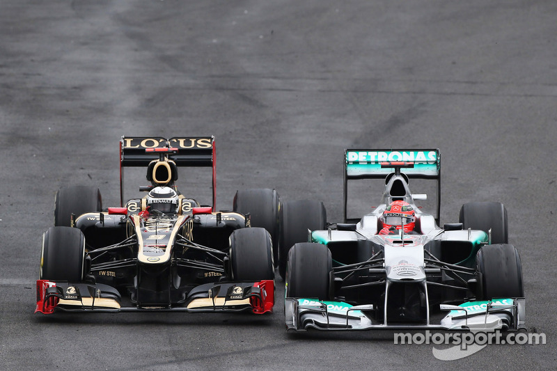 Michael Schumacher, Mercedes AMG F1 and Kimi Raikkonen, Lotus F1 battle for position