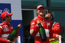 Podium: champagne for Michael Schumacher and Felipe Massa
