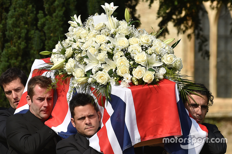 Mark Webber and Dario Franchitti help carry the casket of Justin Wilson during funeral proceedings