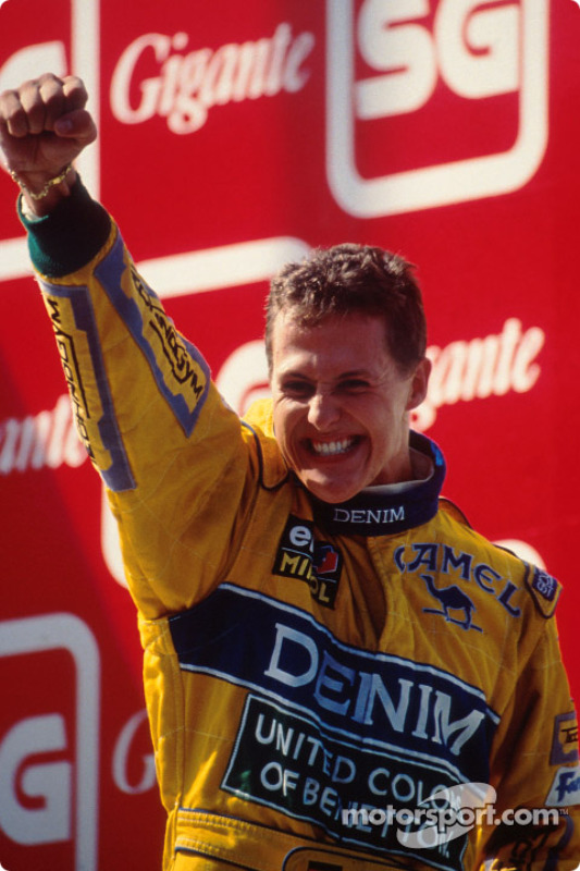 Podium: race winner Michael Schumacher celebrates