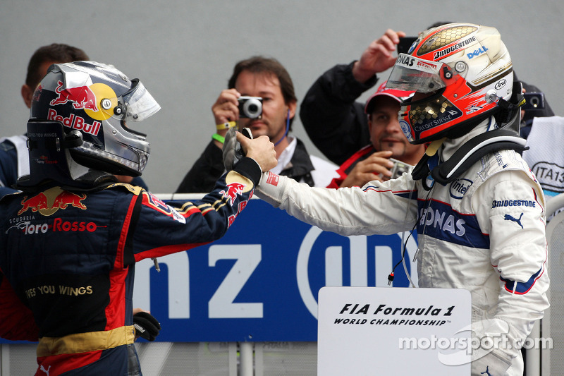 Race winner Sebastian Vettel celebrates with Robert Kubica