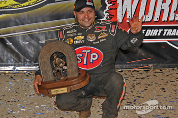 Donny Schatz holds up four fingers in testimony to his four World of Outlaws Sprint Car Series championships